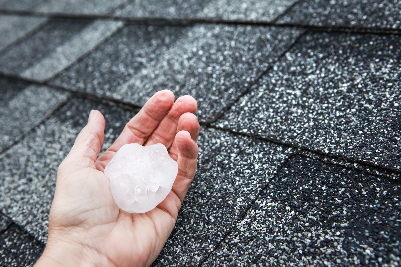 Hail in Hand on a Rooftop after Hailstorm