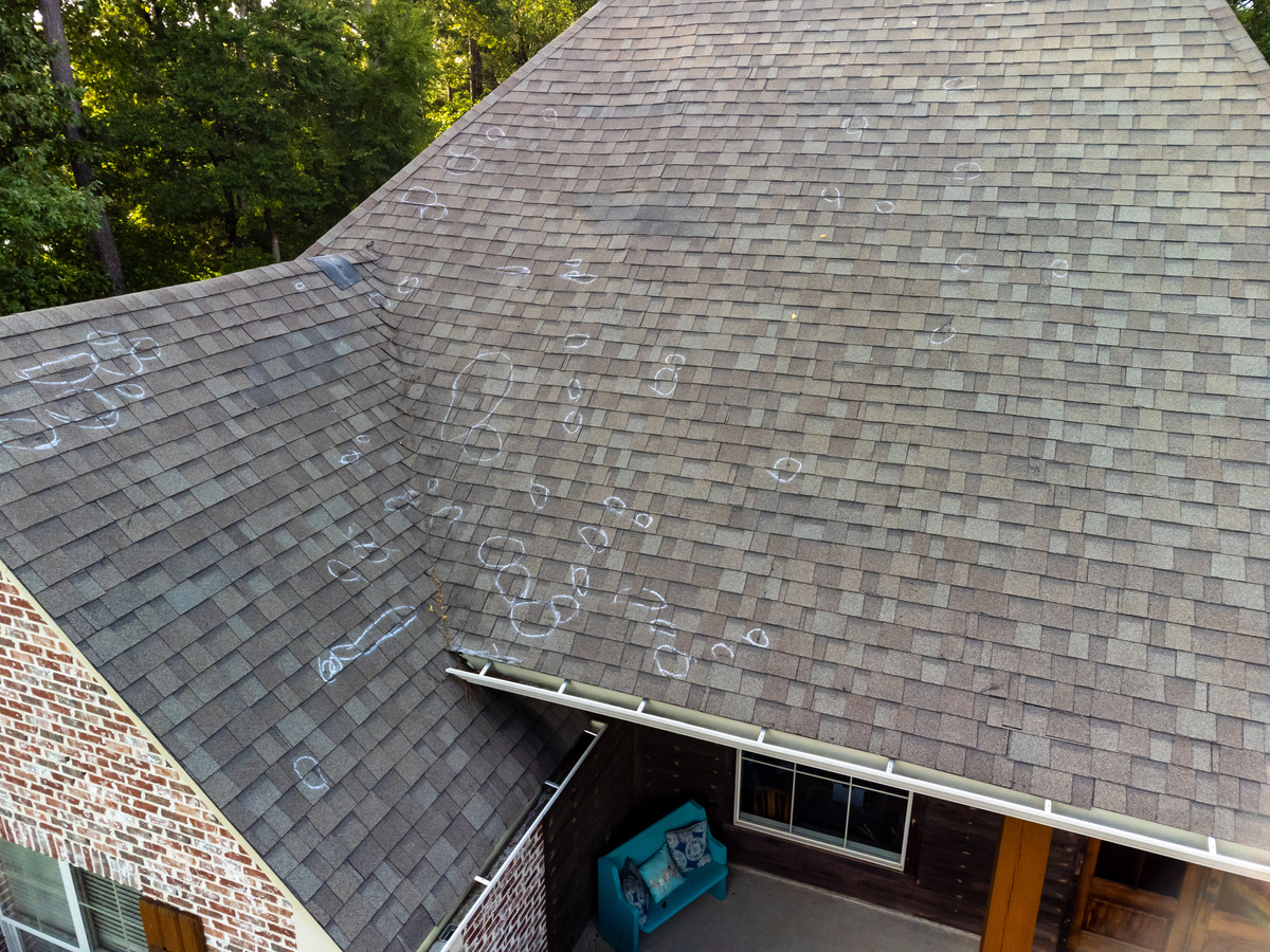 Roof with hail damage and markings from inspection